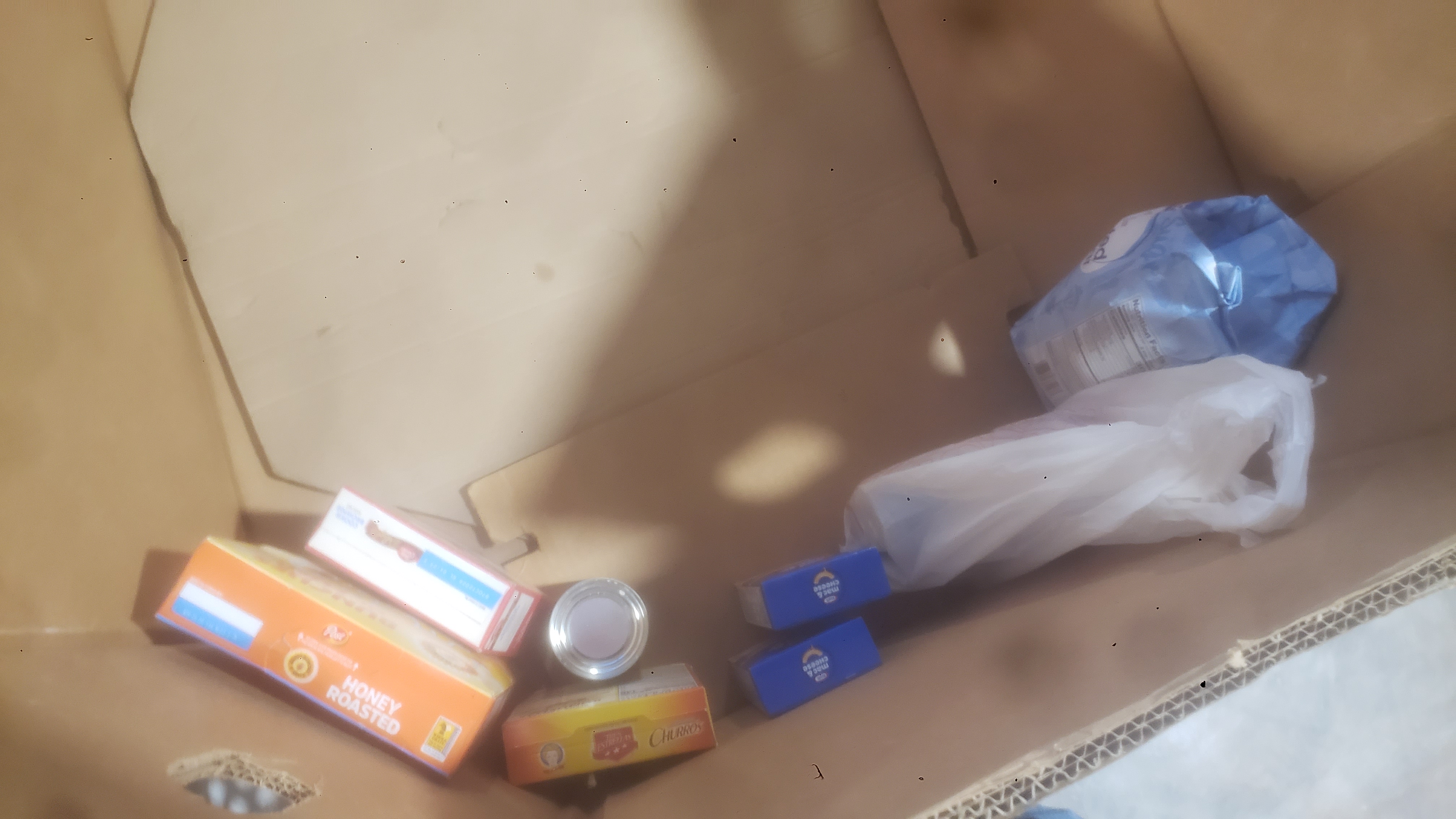 Food items fill the bottom of a cardboard container.